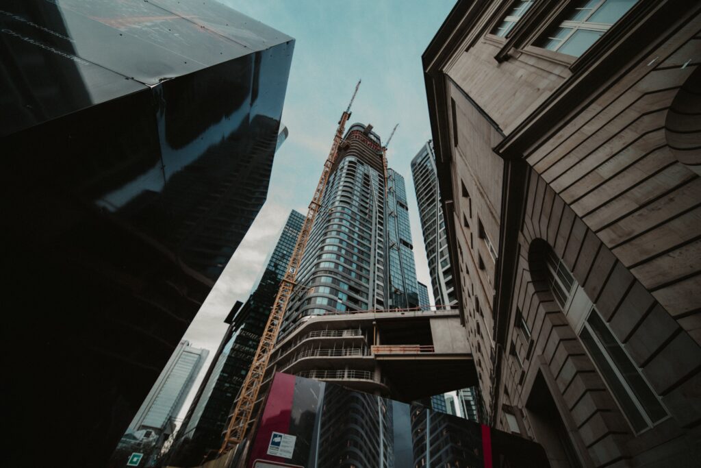 A towering skyscraper under construction in a modern cityscape, showcasing urban development.